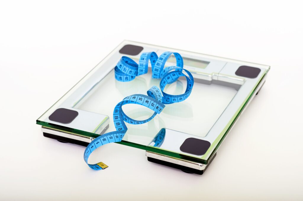 clear digital scale with blue tape measure on top